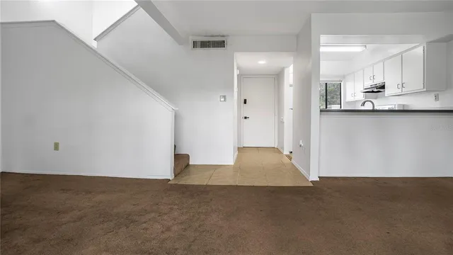 a view of a kitchen with a sink and cabinets