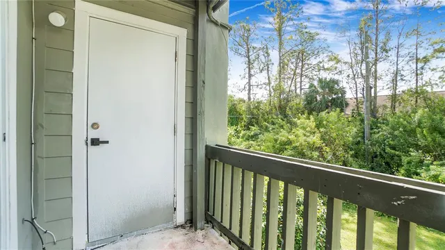 a view of a glass door with a balcony from a window