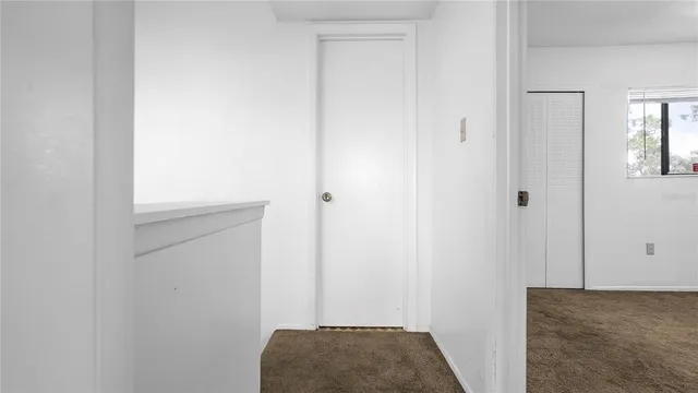 a view of bedroom and hallway