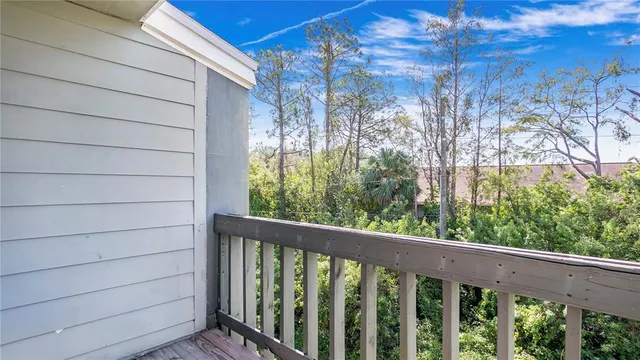 a view of a balcony with wooden fence and floor