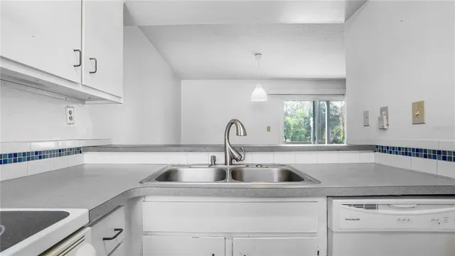 a kitchen with a sink and cabinets