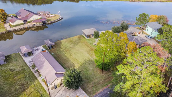 a aerial view of a house with swimming pool lawn chairs and a yard