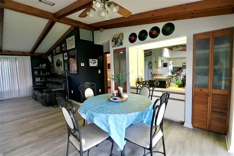a dining room with furniture and wooden floor