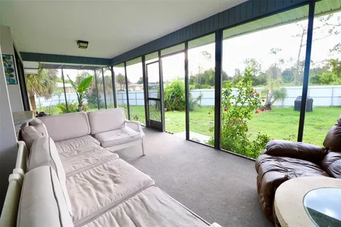 a living room with couch and a large window