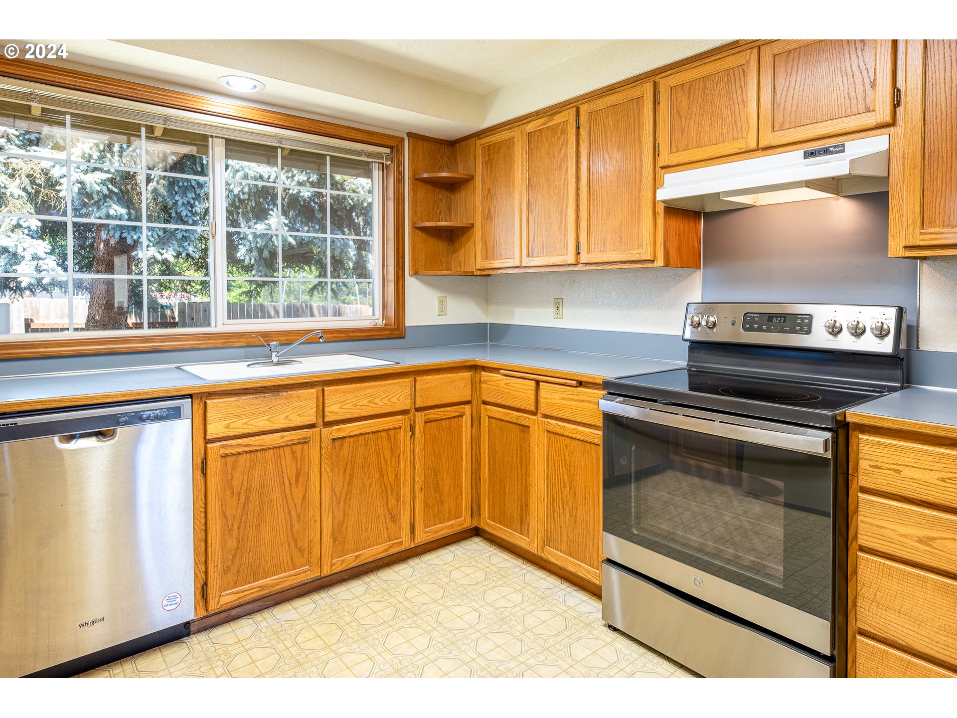 378 70th Street Springfield, OR 97478 - Photo 12 of 39 a kitchen with stainless steel appliances granite countertop a stove a sink and a microwave