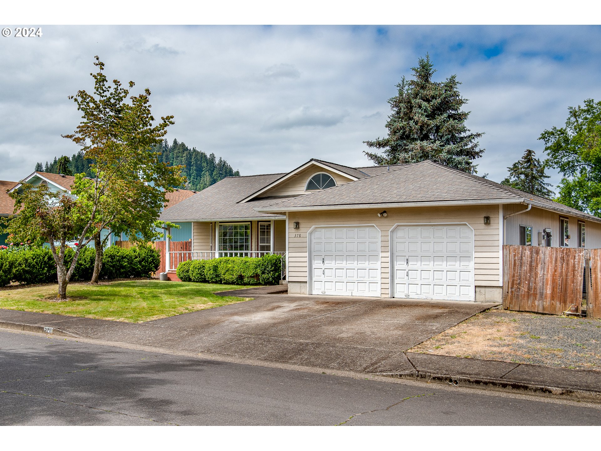 378 70th Street Springfield, OR 97478 - Photo 25 of 39 a front view of a house with a garden and trees