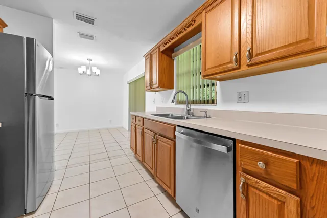 a kitchen with stainless steel appliances a sink stove and refrigerator
