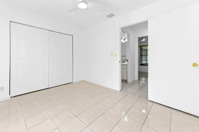 a view of an empty room with closet