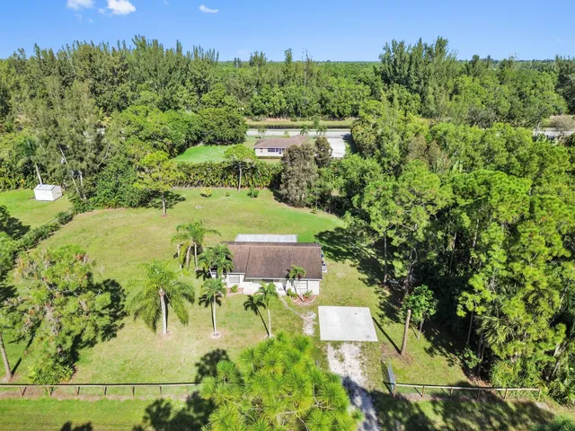 an aerial view of a house with yard swimming pool and outdoor seating