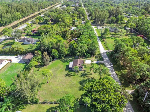 a backyard of a house with a yard and outdoor seating