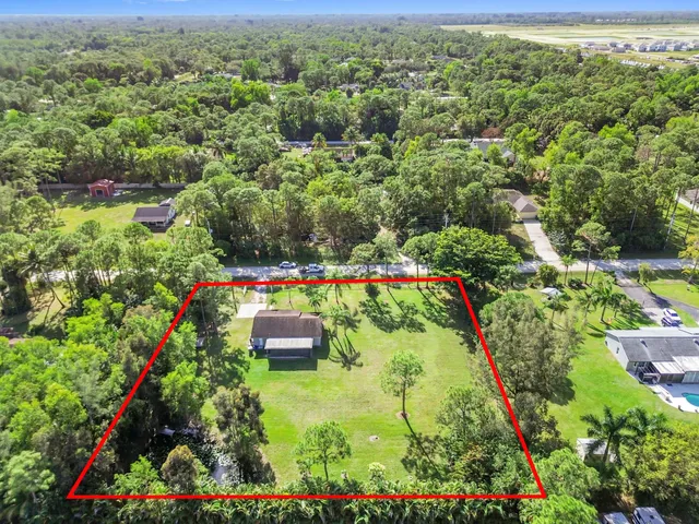 an aerial view of a residential houses with outdoor space