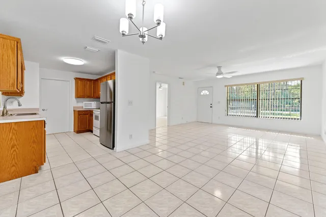 a view of a kitchen with furniture and stainless steel appliances
