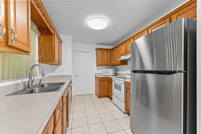 a kitchen with a refrigerator sink and stove
