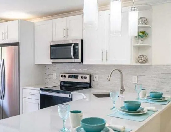 a kitchen with stainless steel appliances a microwave a sink a stove and cabinets