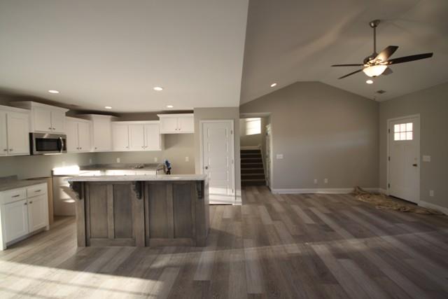 5548 Flewellyn Road Springfield, TN 37172 - Photo 8 of 16 a large kitchen with kitchen island a sink stainless steel appliances and cabinets