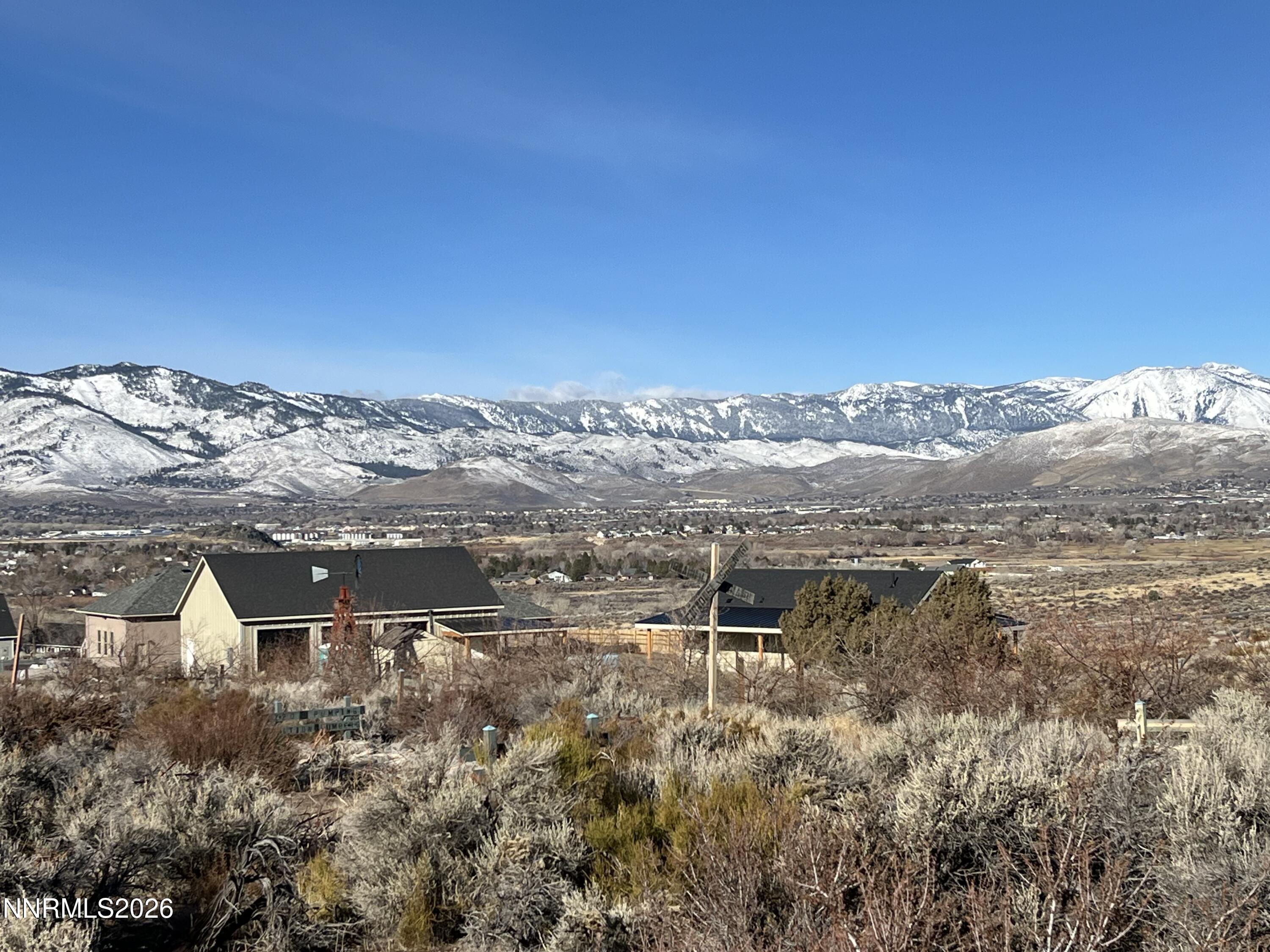 6260 Pursia Road Carson City, NV 89701 - Photo 22 of 26 a view of a lake with a building in the background