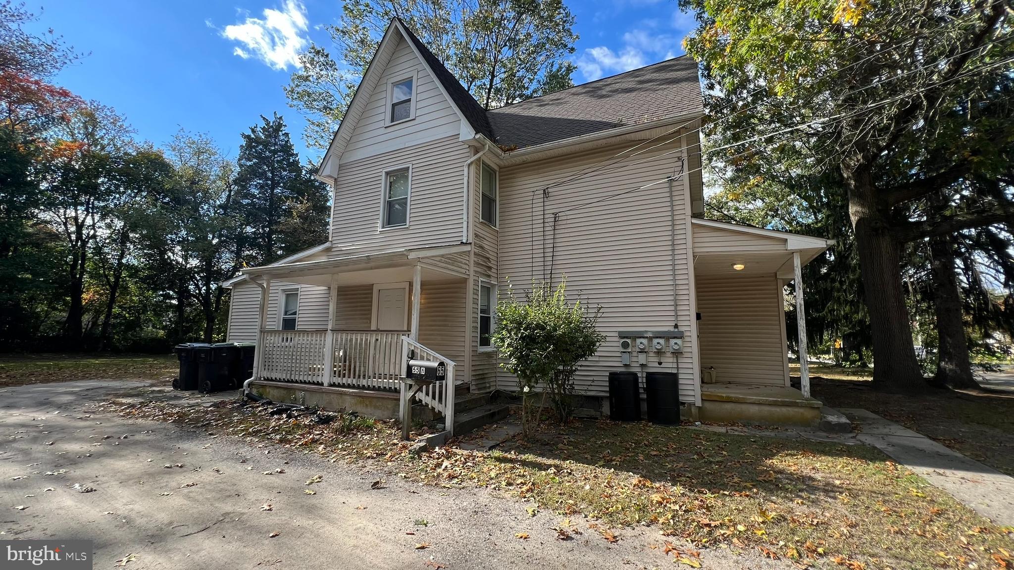 a view of a house with a yard and large tree