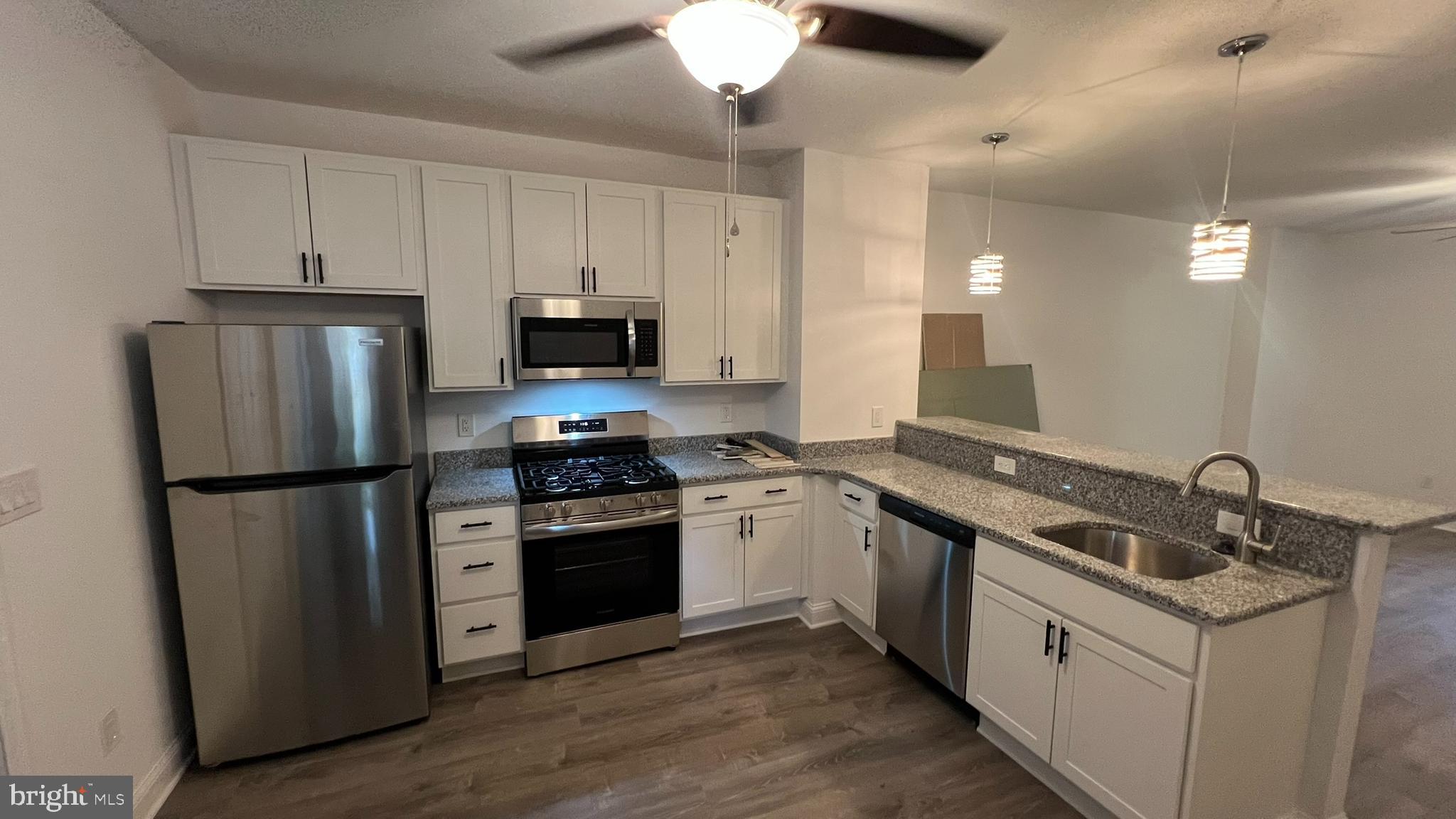 65 Egg Harbor Road, Unit A Berlin, NJ 08009 - Photo 4 of 15 a kitchen with a sink a refrigerator a stove and cabinets