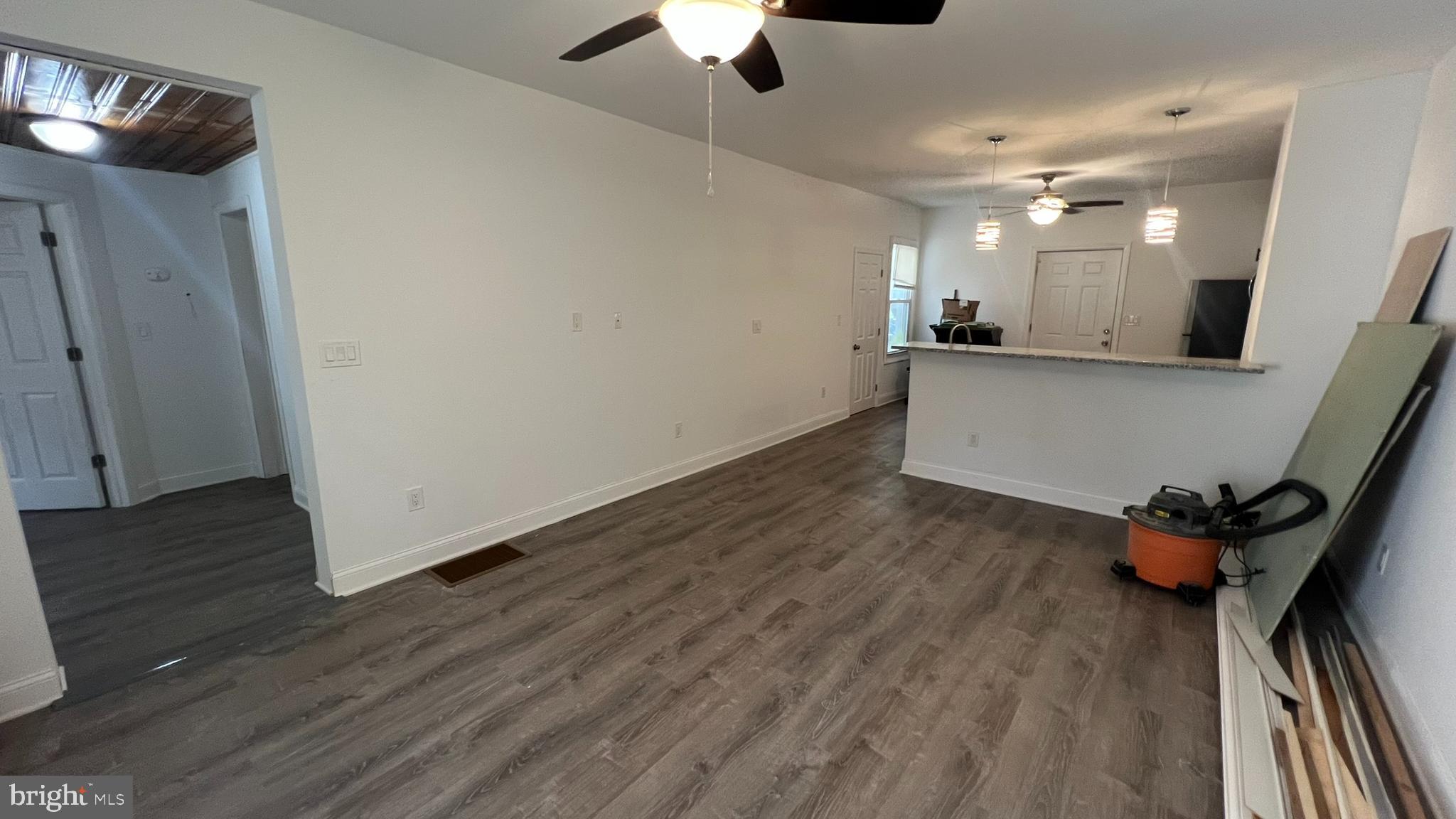65 Egg Harbor Road, Unit A Berlin, NJ 08009 - Photo 9 of 15 a view of a room with wooden floor and a ceiling fan