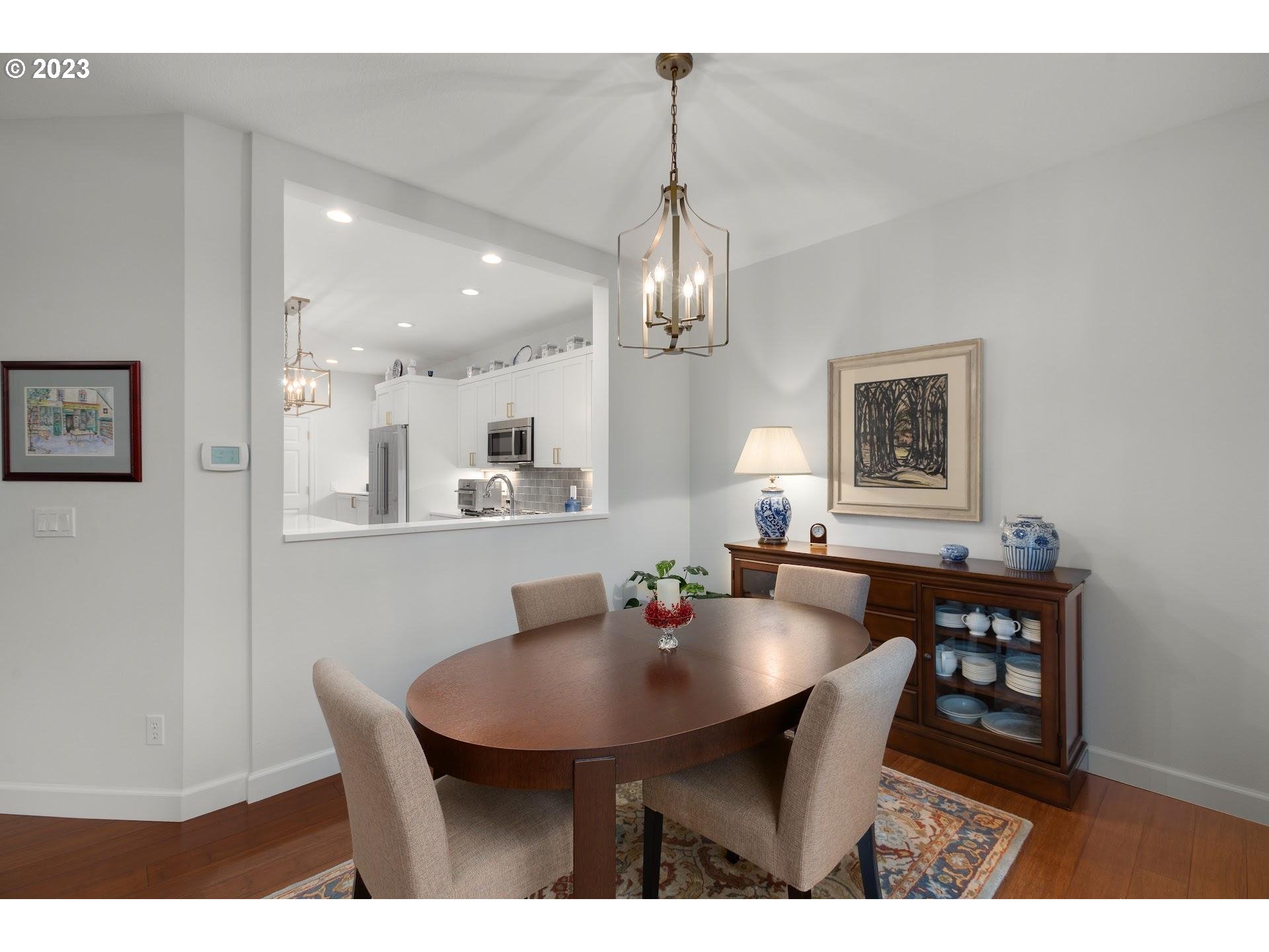 9729 Northwest Silver Ridge Loop Portland, OR 97229 - Photo 14 of 32 a view of a dining room with furniture and chandelier