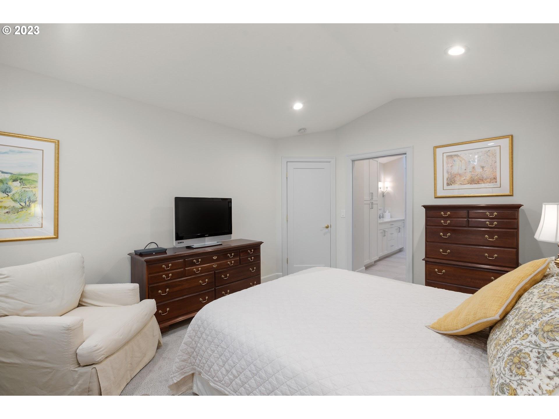 9729 Northwest Silver Ridge Loop Portland, OR 97229 - Photo 18 of 32 a bedroom with a bed and a television