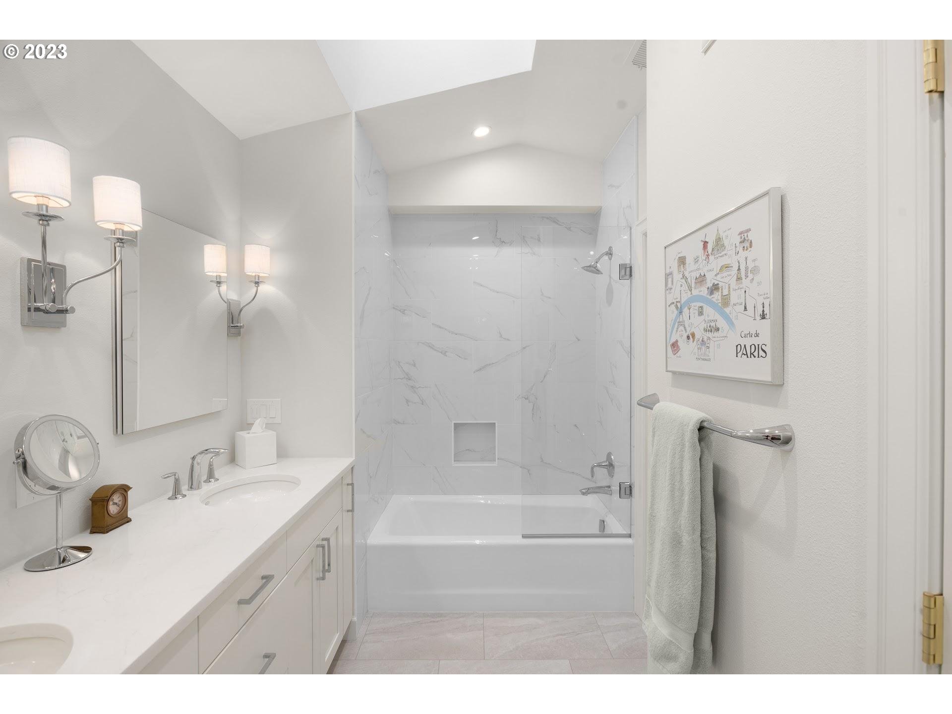 9729 Northwest Silver Ridge Loop Portland, OR 97229 - Photo 19 of 32 a bathroom with a bathtub sink vanity and mirror