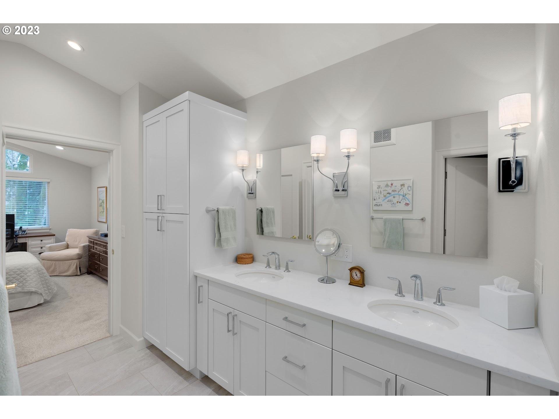 9729 Northwest Silver Ridge Loop Portland, OR 97229 - Photo 20 of 32 a spacious bathroom with a double vanity sink mirror and double