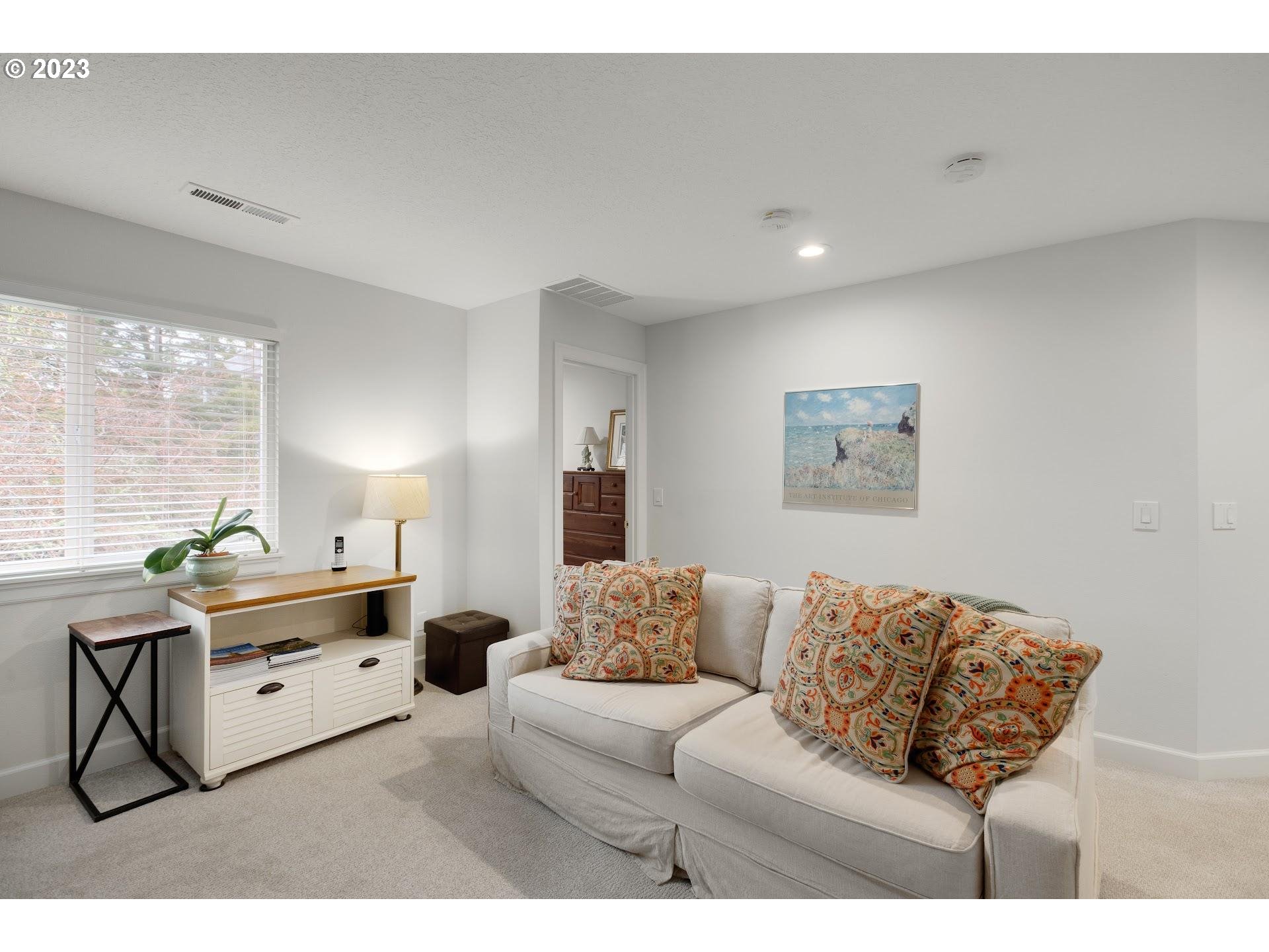9729 Northwest Silver Ridge Loop Portland, OR 97229 - Photo 22 of 32 a living room with furniture and a large window