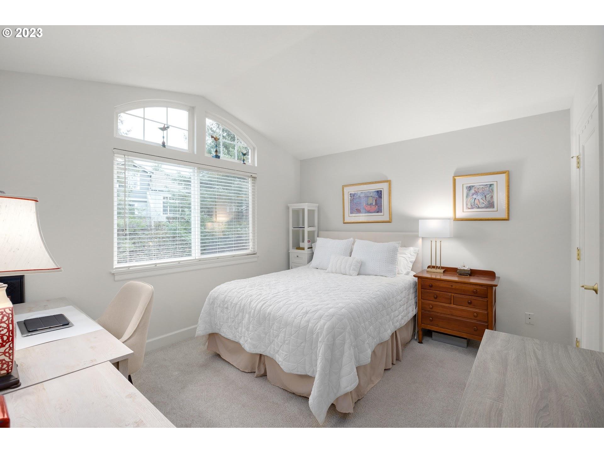 9729 Northwest Silver Ridge Loop Portland, OR 97229 - Photo 25 of 32 a bedroom with a bed and a window