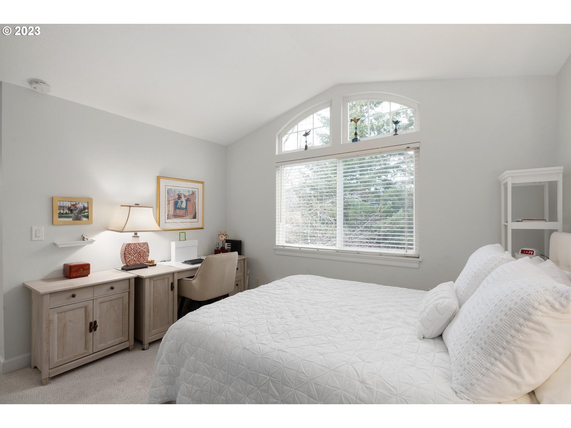 9729 Northwest Silver Ridge Loop Portland, OR 97229 - Photo 26 of 32 a bedroom with a bed and a window