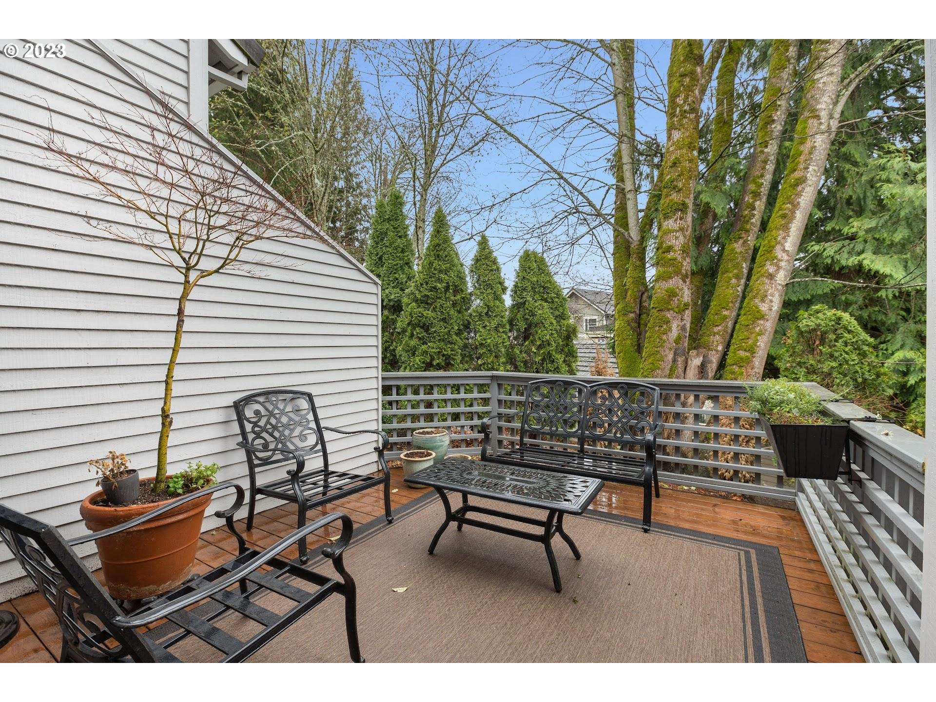9729 Northwest Silver Ridge Loop Portland, OR 97229 - Photo 28 of 32 a roof deck with a couch and wooden floor