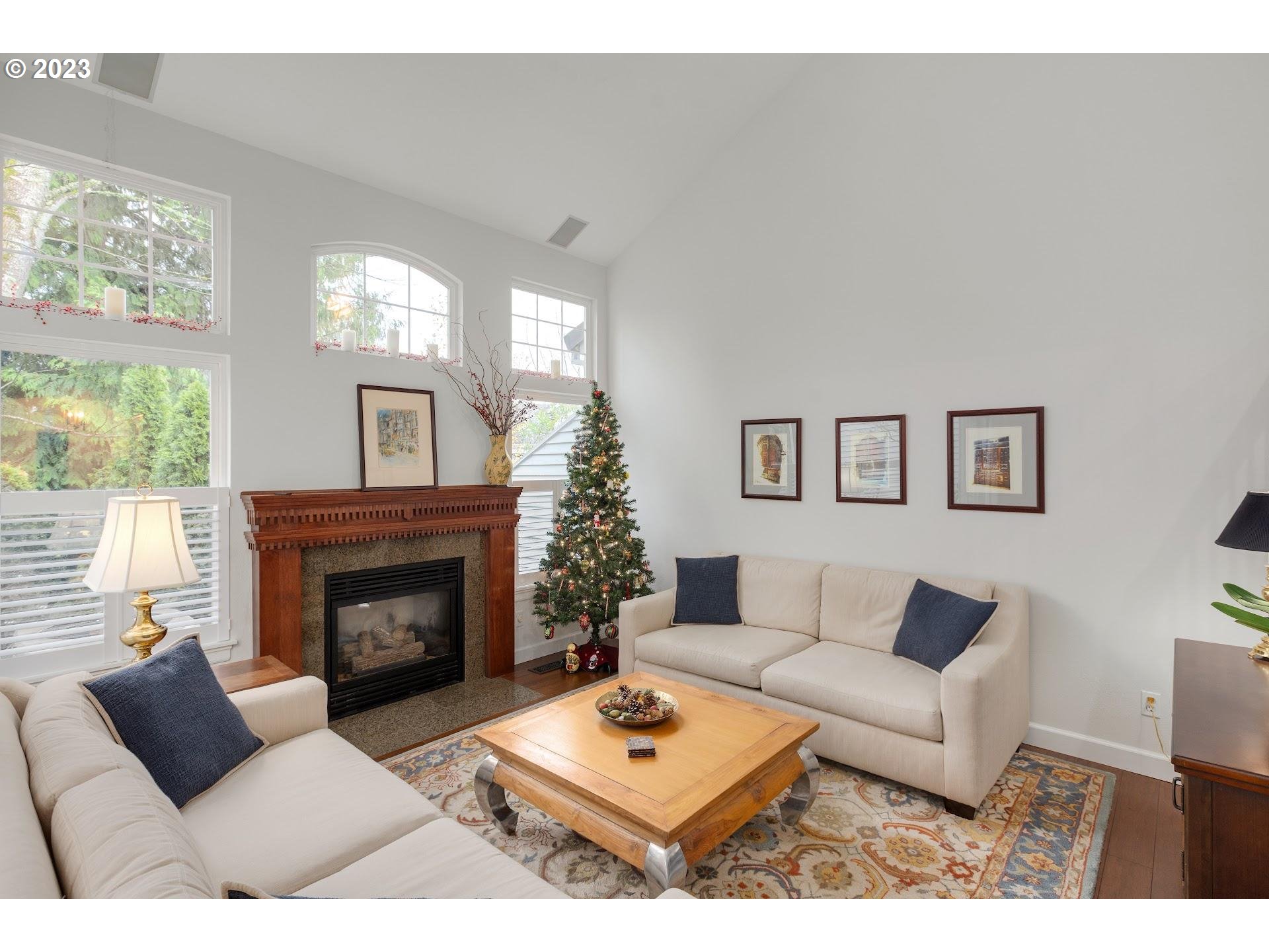9729 Northwest Silver Ridge Loop Portland, OR 97229 - Photo 4 of 32 a living room with furniture and a fireplace