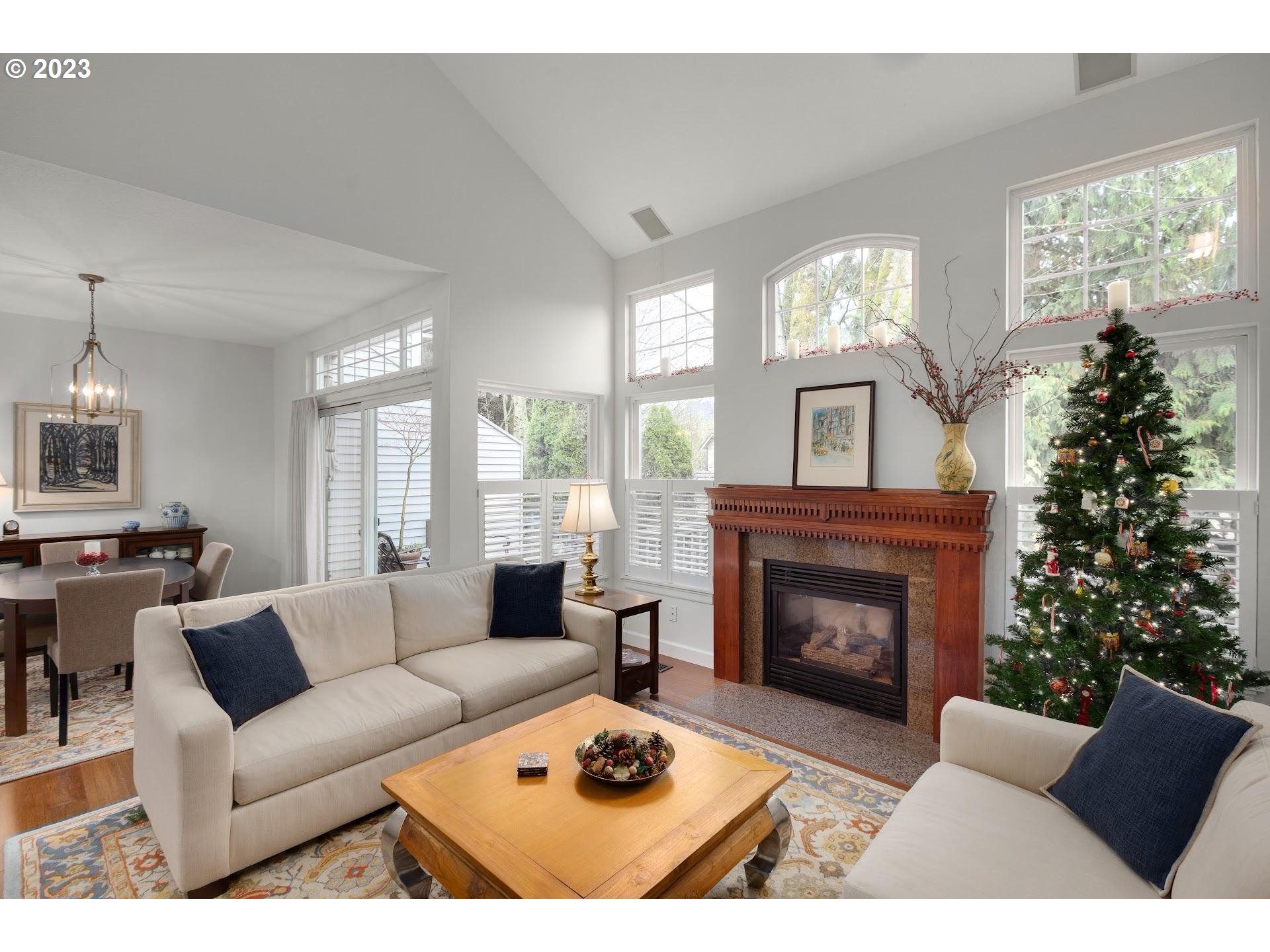 9729 Northwest Silver Ridge Loop Portland, OR 97229 - Photo 5 of 32 a living room with furniture a large window and a fireplace