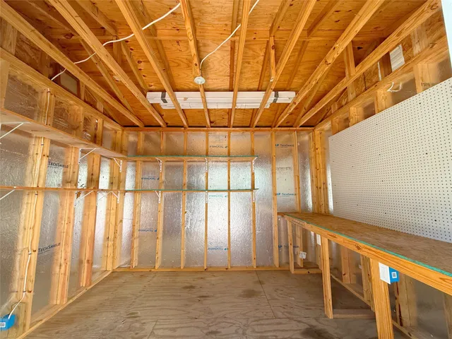 a view of walk in closet with window and wooden floor