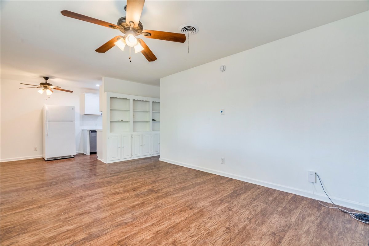 1417 Braes Ridge Drive, Unit B Austin, TX 78723 - Photo 14 of 22 a view of empty room with wooden floor and ceiling fan