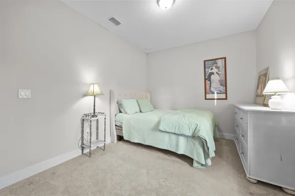 a bedroom with a bed and a lamp on table