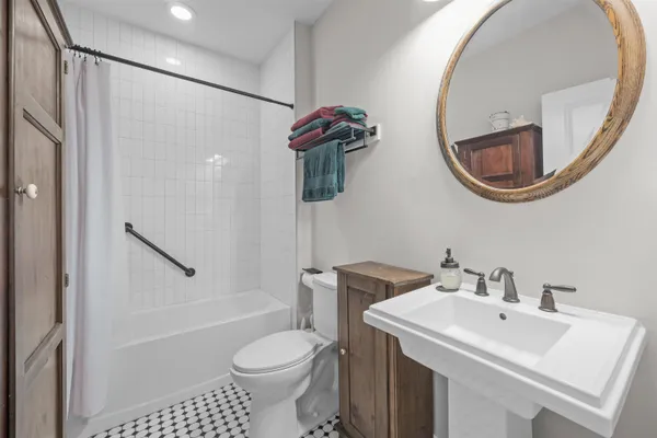 a bathroom with a sink toilet and shower