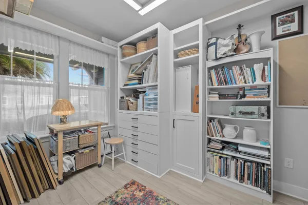 a view of a workspace with furniture and a book shelf