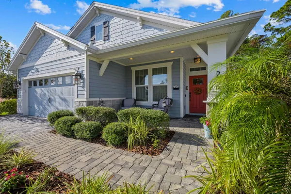 a view of a house with brick walls and potted plants