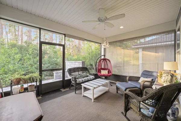 a living room with furniture and a floor to ceiling window