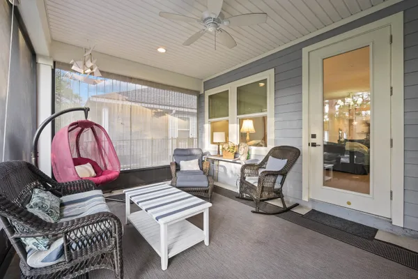 a living room with furniture a rug and white walls