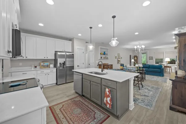 a kitchen that has a lot of cabinets in it and appliances