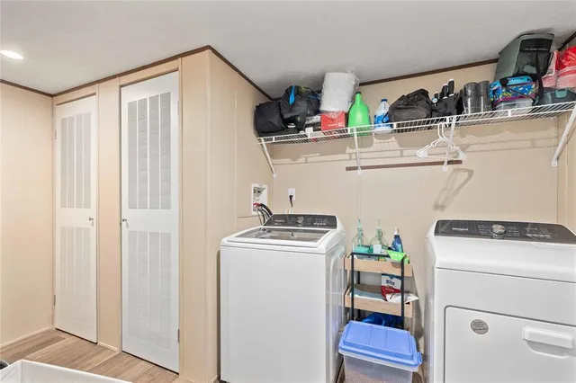 a living room with stainless steel appliances kitchen island granite countertop furniture wooden floor and a kitchen view
