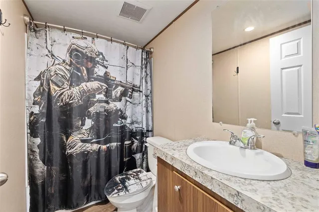 a bedroom with furniture and wooden floor