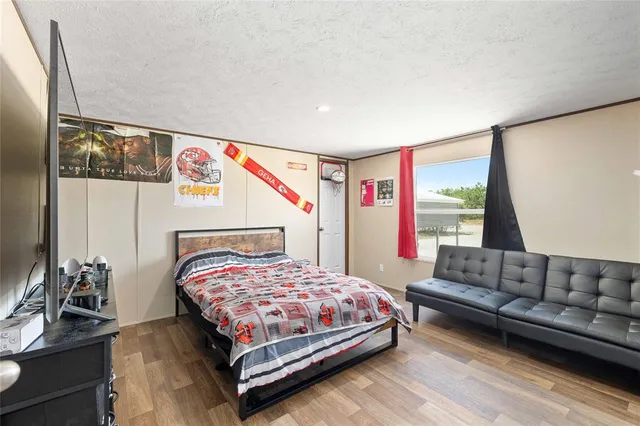 a bathroom with a granite countertop sink a toilet and a shower curtain