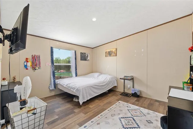 a bedroom with a bed couch and a window