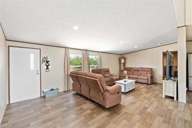 a living room with furniture and large window