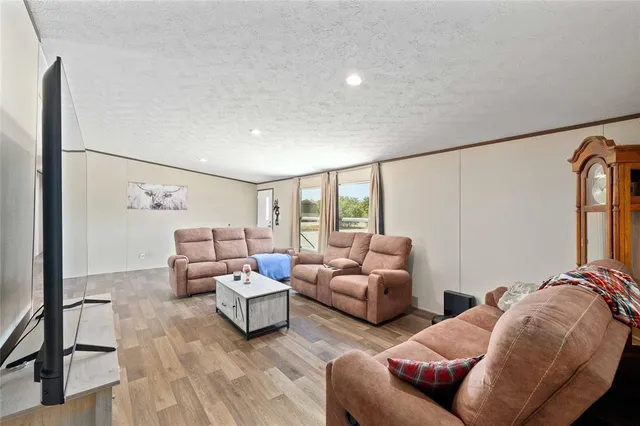 a bedroom with furniture and a large window