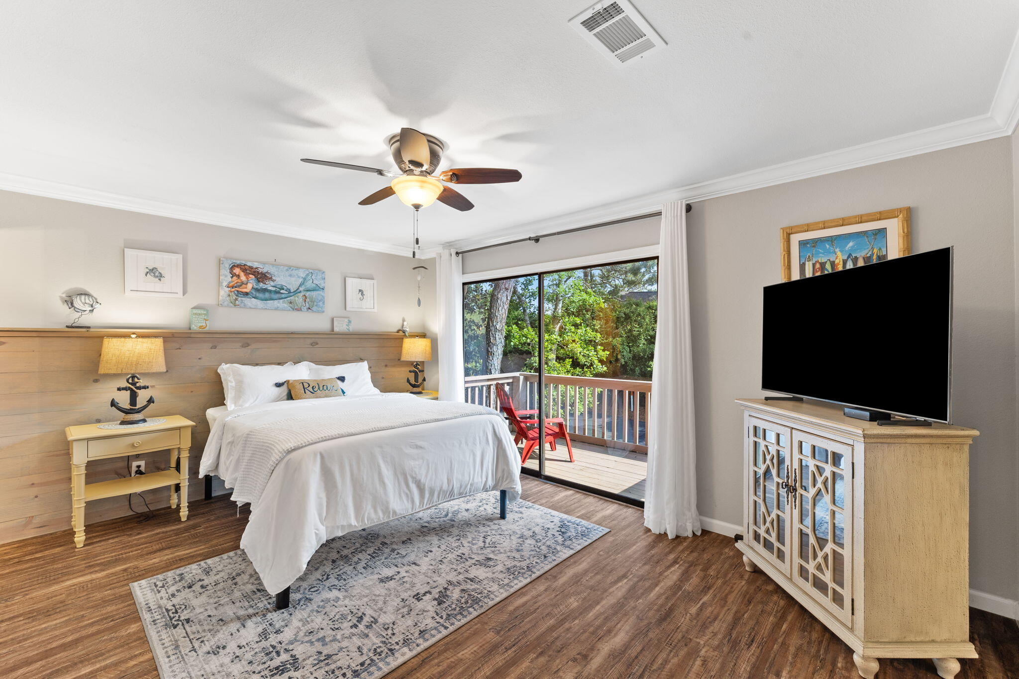 125 Cassine Garden Circle, Unit 129 Santa Rosa Beach, FL 32459 - Photo 17 of 70 a bedroom with a bed and a flat tv screen on wall