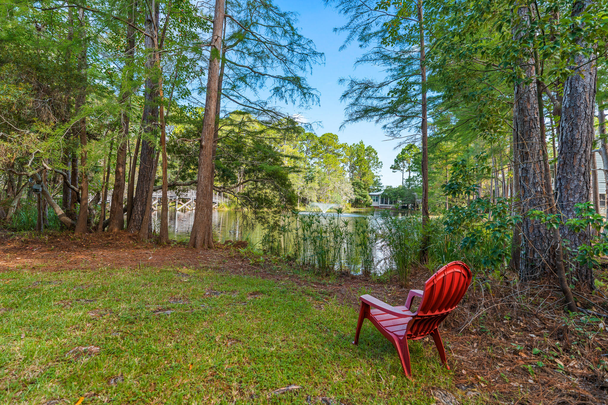 125 Cassine Garden Circle, Unit 129 Santa Rosa Beach, FL 32459 - Photo 34 of 70 a view of a backyard with table and chairs with wooden fence and plants